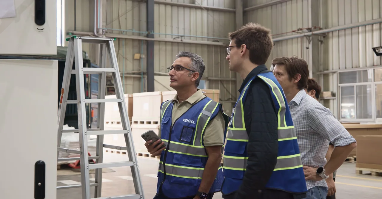 Workers inside a Giga Energy manufacturing facility